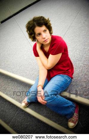 Blurred image of a young woman sitting on the floor in an office building View Large Photo Image Stock Photo - Blurred image of a young woman sitting on the floor in an office building. Fotosearch