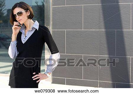Stock Photo - brunette, business, calling, cell phone. Fotosearch