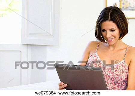 Picture - brunette, computer, at-home. Fotosearch