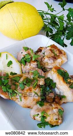 Stock Image - Chicken with lemon and parsley. Fotosearch