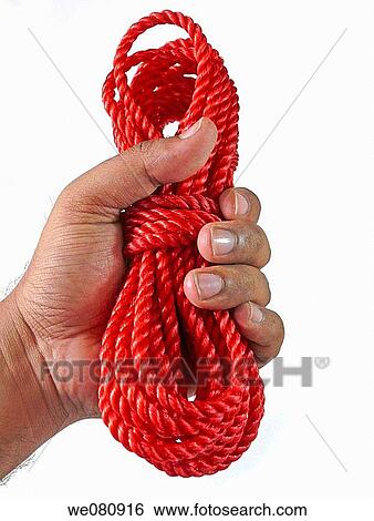 Stock Photograph - Close up braided red nylon heavy duty commericial quality rope in human hand Pune, Maharashtra, India. Fotosearch