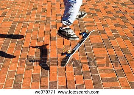Close-up of a teen boy doing a trick on his skateboard. View Large Photo Image Stock Image - Close-up of a teen boy doing a trick on his skateboard.. Fotosearch