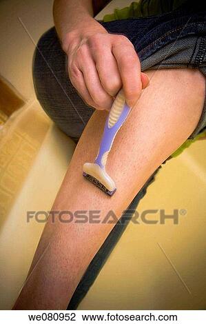 Close-up of a young woman shaving her leg. View Large Photo Image Stock Image - Close-up of a young woman shaving her leg.. Fotosearch
