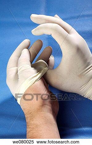 Doctor's hands taking away surgical gloves View Large Photo Image Stock Photography - Doctor's hands taking away surgical gloves. Fotosearch