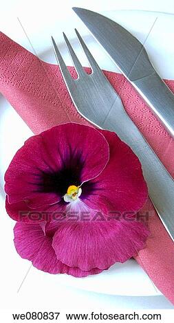 Stock Photo - Edible pansy and cutlery. Fotosearch