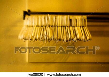 Empty plastic coat hangers hanging together. View Large Photo Image Stock Image - Empty plastic coat hangers hanging together.. Fotosearch