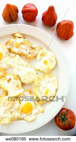 Fried quail eggs and tomatoes View Large Photo Image Stock Photography - Fried quail eggs and tomatoes. Fotosearch