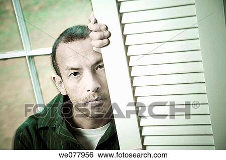 Hispanic man posing in front of a window View Large Photo Image Stock Photograph - Hispanic man posing in front of a window. Fotosearch