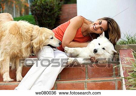 Lady in her 40s relaxing with her dogs View Large Photo Image Stock Photograph - Lady in her 40s relaxing with her dogs. Fotosearch