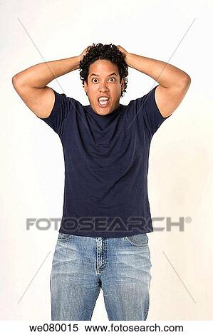 Latin man looking at the camera pulling his hair surprised View Large Photo Image Stock Photography - Latin man looking at the camera pulling his hair surprised. Fotosearch
