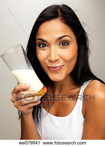Stock Image - Latin model drinking glass of milk. Fotosearch