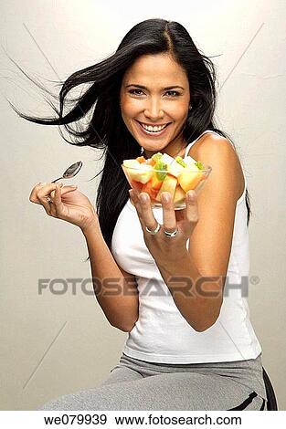 Latin model eating fruit plate View Large Photo Image Stock Photo - Latin model eating fruit plate. Fotosearch