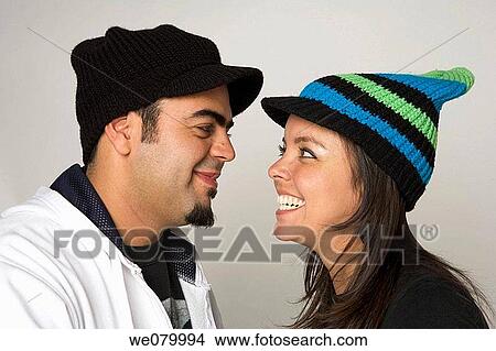Picture - Latin young couple looking at each other. Fotosearch