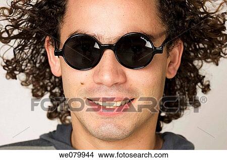 Model in his 30s with long hair and sunglasses smiling at the camera View Large Photo Image Picture - Model in his 30s with long hair and sunglasses smiling at the camera. Fotosearch