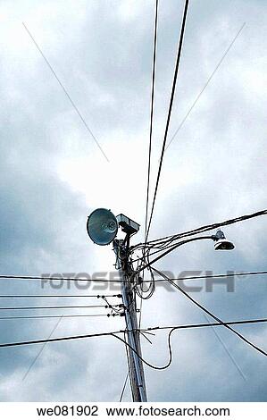 Power lines with a streetlight and loudspeaker. View Large Photo Image Stock Image - Power lines with a streetlight and loudspeaker.. Fotosearch