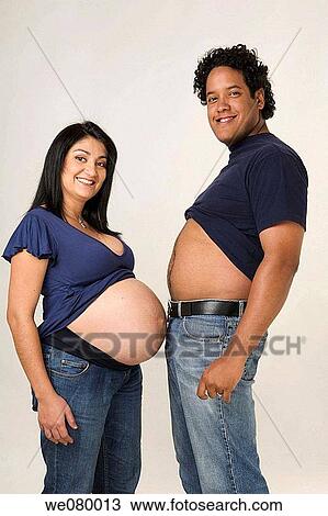 Pregnant woman and her husband showing their tummies View Large Photo Image Stock Image - Pregnant woman and her husband showing their tummies. Fotosearch