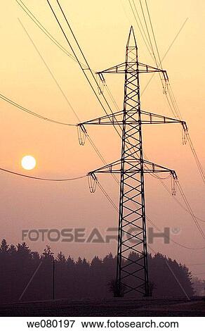 Sunrise in fogy mist on a cold winter morning, power lines near forest, Gossau, Zuerich, Switzerland View Large Photo Image Stock Photo - Sunrise in fogy mist on a cold winter morning, power lines near forest, Gossau, Zuerich, Switzerland. Fotosearch