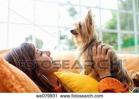 Woman in her late 30s playing with her dog View Large Photo Image Stock Image - Woman in her late 30s playing with her dog. Fotosearch