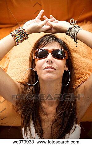 Woman in her late 30s relaxing at home wearing sunglasses View Large Photo Image Stock Image - Woman in her late 30s relaxing at home wearing sunglasses. Fotosearch