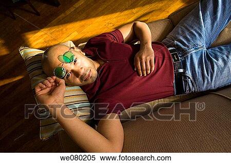 Young Hispanic man, wearing green sunglasses, posing View Large Photo Image Stock Photography - Young Hispanic man, wearing green sunglasses, posing. Fotosearch