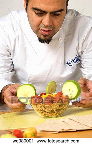 Young latin Chef giving final touches to decorated serial bowl View Large Photo Image Stock Image - Young latin Chef giving final touches to decorated serial bowl. Fotosearch