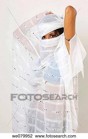 Young Latin model in her 20s dressed as an arab dancer hiding her face with a veil View Large Photo Image Stock Image - Young Latin model in her 20s dressed as an arab dancer hiding her face with a veil. Fotosearch