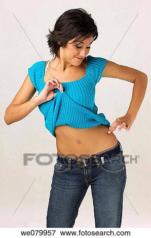 Young Latin model in her 20s pinching her trim waist View Large Photo Image Stock Photo - Young Latin model in her 20s pinching her trim waist. Fotosearch