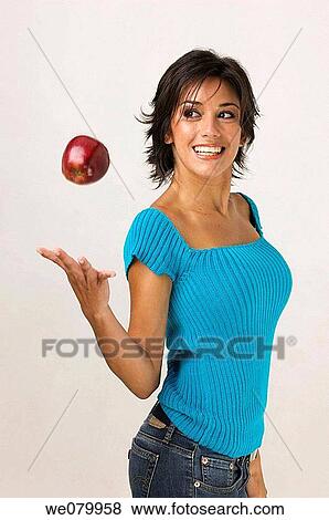Young Latin model in her 20s playing with an apple View Large Photo Image Stock Photo - Young Latin model in her 20s playing with an apple. Fotosearch