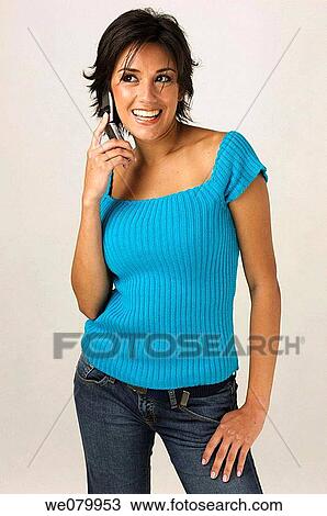 Young Latin model in her 20s talking on a cell phone smiling View Large Photo Image Stock Image - Young Latin model in her 20s talking on a cell phone smiling. Fotosearch
