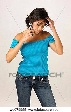 Young Latin model in her 20s talking on a cell phone worried View Large Photo Image Stock Photography - Young Latin model in her 20s talking on a cell phone worried. Fotosearch