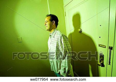Young man posing in his apartment View Large Photo Image Picture - Young man posing in his apartment. Fotosearch