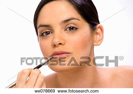 Young woman applying make-up View Large Photo Image Stock Photo - Young woman applying make-up. Fotosearch