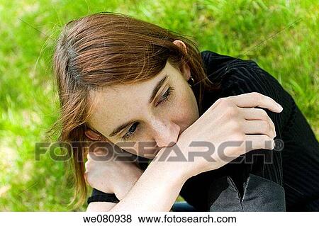 Young woman posing in a park. View Large Photo Image Stock Photo - Young woman posing in a park.. Fotosearch
