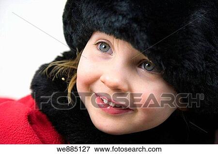 Stock Photo - 3 years old girl in red coat with fur collar, cuffs and hat against white background. Fotosearch