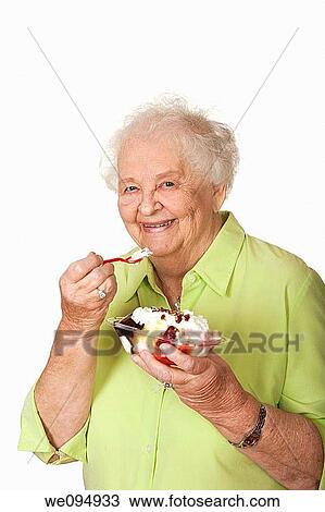 A beautiful elderly Caucasian woman eating a banana split icecream View Large Photo Image Stock Image - A beautiful elderly Caucasian woman eating a banana split icecream. Fotosearch