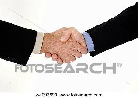 Stock Image - A caucasian businessman in a black business suit and white shirt He is shown on a white background shaking hands. Fotosearch