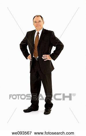 A caucasian businessman with a receding hairline wearing a black business suit and white shirt He is shown on a white background with hands on hips and is smiling View Large Photo Image Stock Photo - A caucasian businessman with a receding hairline wearing a black business suit and white shirt He is shown on a white background with hands on hips and is smiling. Fotosearch