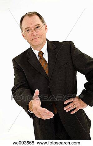 A caucasian businessman with a receding hairline wearing a gray business suit and white shirt He is shown on a white background with reaching out shake someones hand View Large Photo Image Stock Photo - A caucasian businessman with a receding hairline wearing a gray business suit and white shirt He is shown on a white background with reaching out shake someones hand. Fotosearch