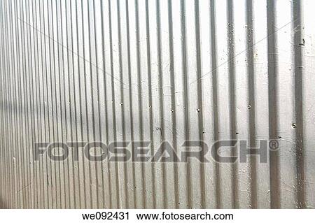 Stock Image - A close-up of a corrugated steel fence. Fotosearch