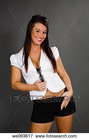 A female caucasian wearing an casual outfit with a white blouse She is on a gray background hold sunglasses View Large Photo Image Stock Photo - A female caucasian wearing an casual outfit with a white blouse She is on a gray background hold sunglasses. Fotosearch