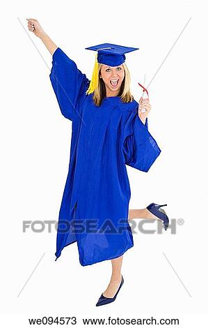 A female caucasian with blond hair standing in blue graduation gown and smiling She is on a white background View Large Photo Image Stock Image - A female caucasian with blond hair standing in blue graduation gown and smiling She is on a white background. Fotosearch