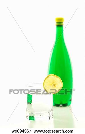 A glass of sparkling water with a slice of lemon View Large Photo Image Stock Photo - A glass of sparkling water with a slice of lemon. Fotosearch