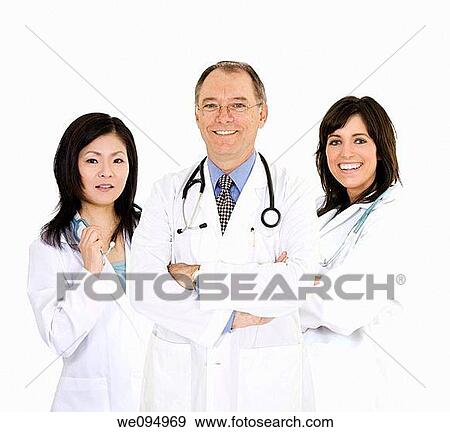 A group of confident doctors smiling over a white background View Large Photo Image Stock Photo - A group of confident doctors smiling over a white background. Fotosearch