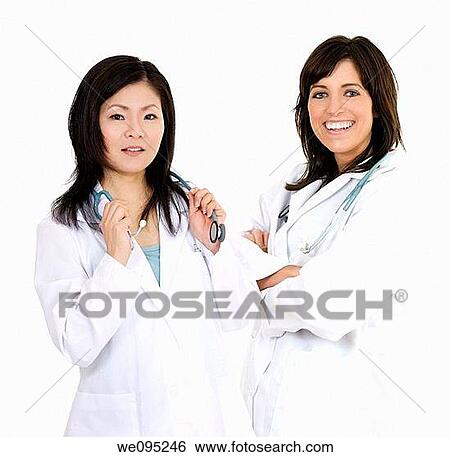 A group of confident doctors smiling over a white background View Large Photo Image Stock Photograph - A group of confident doctors smiling over a white background. Fotosearch