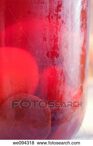 Stock Photo - A jar of boiled eggs being pickled with vinegar and beats. Fotosearch