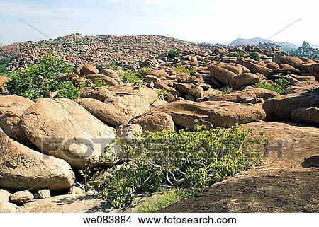 A stunning rock formation at Hampi, Karnataka. Hampi is situated on the banks of the Tungabhadra river within the ruins of Vijayanagara, the former capital of the Vijayanagara empire from 1336 to 1565. The name is derived from Pampa, which is the old name View Large Photo Image Picture - A stunning rock formation at Hampi, Karnataka. Hampi is situated on the banks of the Tungabhadra river within the ruins of Vijayanagara, the former capital of the Vijayanagara empire from 1336 to 1565. The name is derived from Pampa, which is the old name. Fotosearch