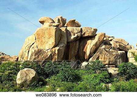 A stunning rock formation at Hampi, Karnataka. Hampi is situated on the banks of the Tungabhadra river within the ruins of Vijayanagara, the former capital of the Vijayanagara empire from 1336 to 1565. The name is derived from Pampa, which is the old name View Large Photo Image Stock Photograph - A stunning rock formation at Hampi, Karnataka. Hampi is situated on the banks of the Tungabhadra river within the ruins of Vijayanagara, the former capital of the Vijayanagara empire from 1336 to 1565. The name is derived from Pampa, which is the old name. Fotosearch