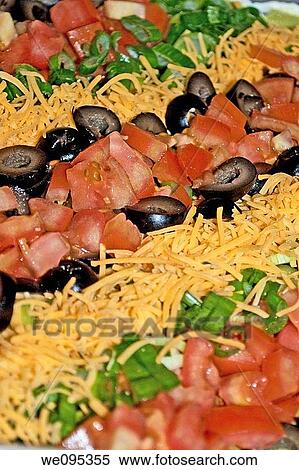 A taco salad laid out in rows of black olives, tomatoes, green onions and cheese View Large Photo Image Stock Photography - A taco salad laid out in rows of black olives, tomatoes, green onions and cheese. Fotosearch
