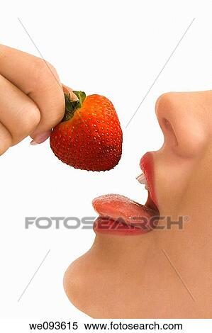 A very sensual image of a Caucasian woman about to taste a strawberry View Large Photo Image Stock Photography - A very sensual image of a Caucasian woman about to taste a strawberry. Fotosearch