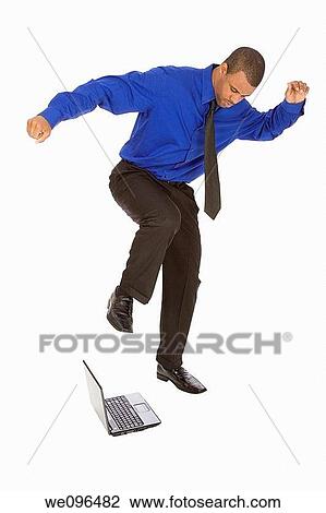 African American businessman kicking a computer on white background View Large Photo Image Stock Image - African American businessman kicking a computer on white background. Fotosearch